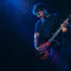 male guitarist playing feat