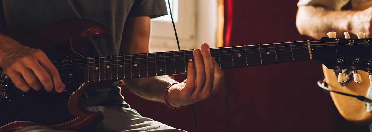 Man hand playing electric guitar