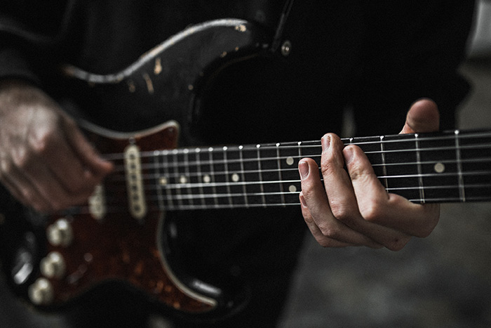 Man hand playing electric guitar