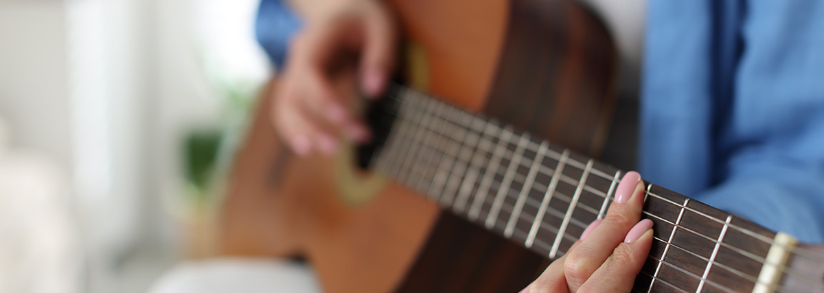 Woman hand playing guitar