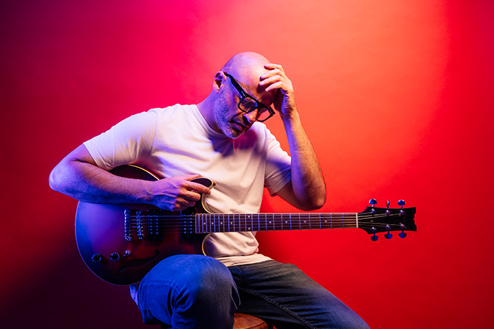 Male guitarist feeling annoyed
