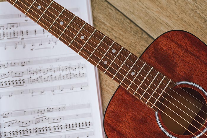Guitarist practising classical guitar technique and finger placement at home